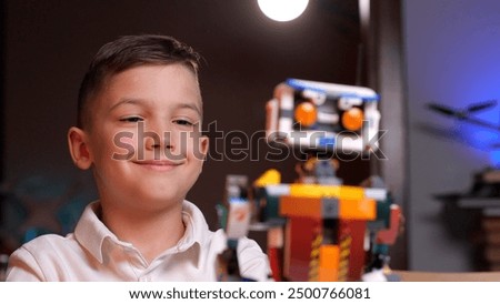 Happy child programming robot from building blocks at home