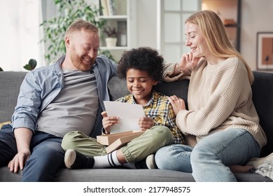 Happy Child Reading A Letter About Adoption