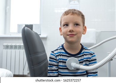 A Happy Child Receives Treatment At A Visit To A Doctor In A Private Clinic. Electromagnetic Stimulation Of The Chest. Smiling Kid. Recovery Of Children After Physiotherapy In A Hospital. Medicine