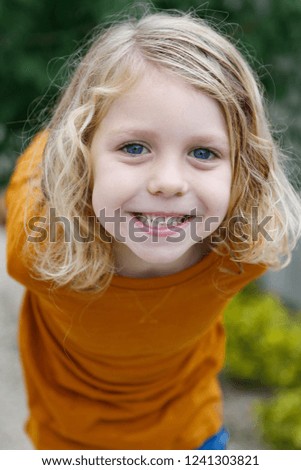 Similar – Small child with long blond hair enjoying of a sunny day