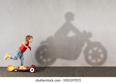 Happy Child Riding Scooter. Funny Kid Dreams About Bike. Imagination, Freedom And Motivation Concept