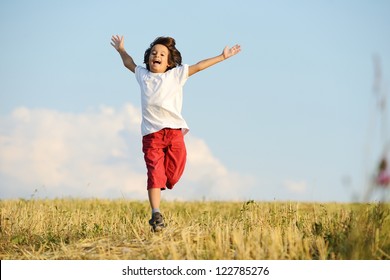 Happy Child Running On Beautiful Field
