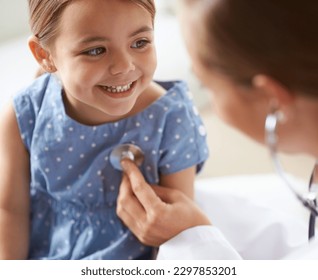 Happy, child and stethoscope of pediatrician for healthcare consulting, check lungs and breathing for heartbeat. Medical doctor, kid and chest assessment in clinic, hospital and helping girl patient - Powered by Shutterstock