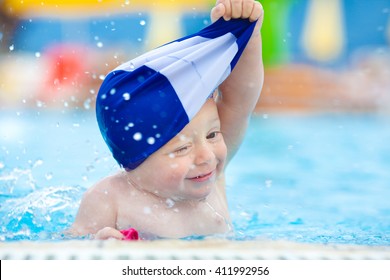 Happy Child With Swimming Pool Cap Have Fun In A Pool