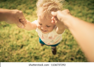 Happy Child Swinging Spinning Around In Fathers Arms. 