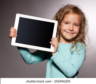 Happy child with tablet computer. Kid showing