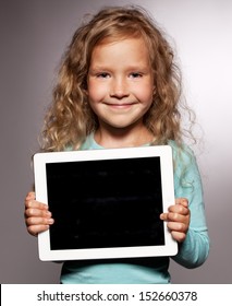 Happy Child With Tablet Computer. Kid Showing Tablet Screen