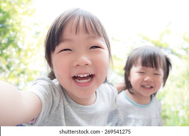 Happy Child Take A Selfie In The Park, Asian