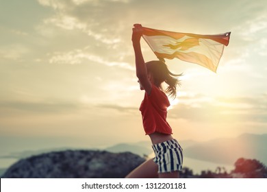 Happy child teenage girl waving the flag of Canada while running at sunset - Shutterstock ID 1312201181
