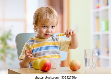 Happy Child Toddler Eating Food Cheese With Fruits At Home