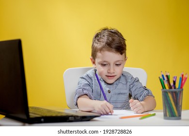 Happy Child Using Digital Laptop Doing Homework On Yellow Background. Social Distancing, E-learning Online Education.