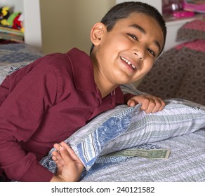 Happy Child Wakes Up To Find Money Under His Pillow Left By The Tooth Fairy