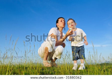 Similar – Mother playing with her daughter on the grass