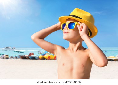 Happy Child In Yellow Sunglasses On Beach. Summer Vacation Concept