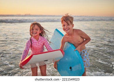 Happy children, beach and learning to surf for fun and bonding on bali summer vacation. Kids, boy and girl siblings on tropical holiday while surfing with board for water sports, splash and swim - Powered by Shutterstock