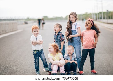 Happy Children From Different Cultures Having Fun Together. Playing, Talking, Laughing. The Concept Of Friendship And Intercultural Communication