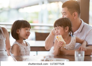 Happy children eating toast bread at cafeteria. Asian family outdoor lifestyle with natural light. - Powered by Shutterstock