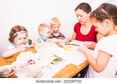 Happy children are engaged with modeling clay