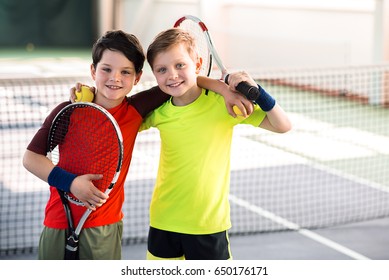 Happy children entertaining on tennis court