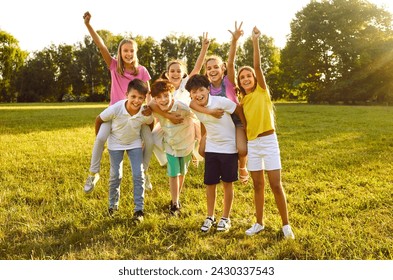 Happy children friends standing together outdoors, having fun and smiling in the park on holidays enjoying spending time in a summer camp. Portrait of a kids looking at camera having weekend activity - Powered by Shutterstock