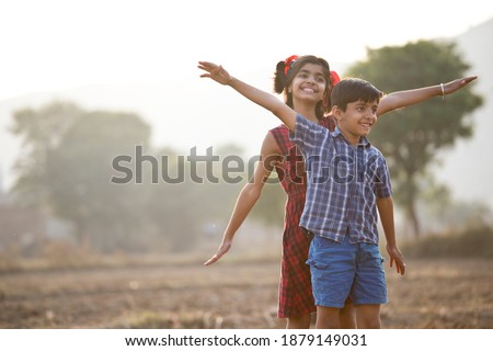 Happy children having fun in agricultural field
