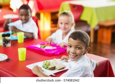 Happy Children Having Lunch During Break Time In School Cafeteria