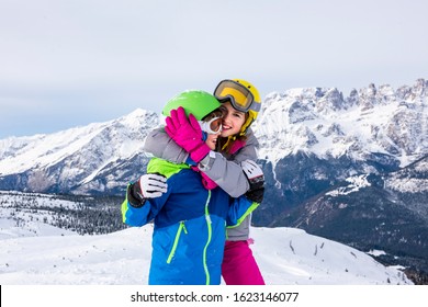 Happy children with helmet and goggles on the ski slopes - Shutterstock ID 1623146077