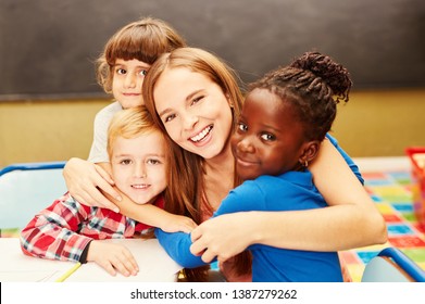 Happy children hug their childminder in child care