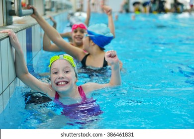 happy children kids group at swimming pool class learning to swim - Shutterstock ID 386461831