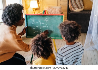 Happy children learning maths with mother, teacher at home. Family education happiness concept - Powered by Shutterstock