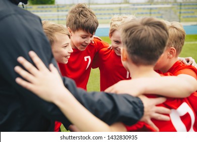 Happy Children Making Sport. Group Of Happy Boys Making Sports Huddle. Smiling Kids Standing Together With Coach On Grass Sports Field. Boys Talking With Coach Before The Football Game