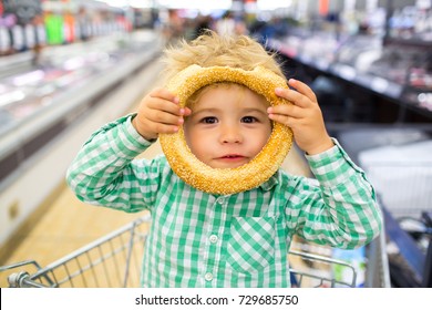 Happy children meal. For childish menu poster. Funny food story. Great choice of food. Cute funny boy in supermarket playing with rollaway bun. Snack in children's menu. Funny kid portrait gluten free