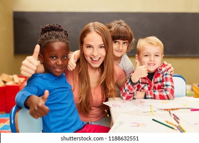 Happy children in multicultural kindergarten keep their thumbs up - Powered by Shutterstock