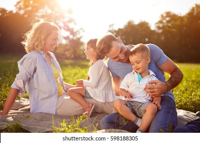 Happy children with parents in nature - Shutterstock ID 598188305