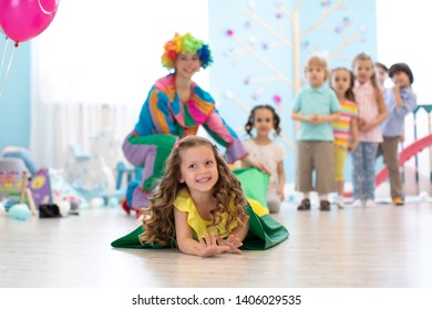 Happy Children Playing In Childrens Playroom For Birthday Party Or Entertainment Centre. Kids Amusement Park And Play Center Indoors.