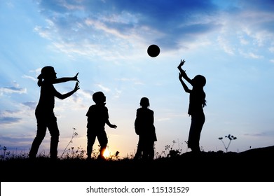 Happy children playing hand ball at sunset time