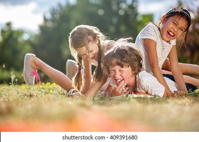 Happy Children Playing And Having Fun In Summer 