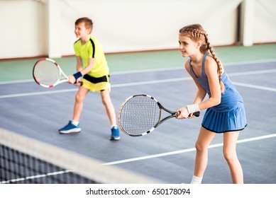 Happy children playing sport game on court