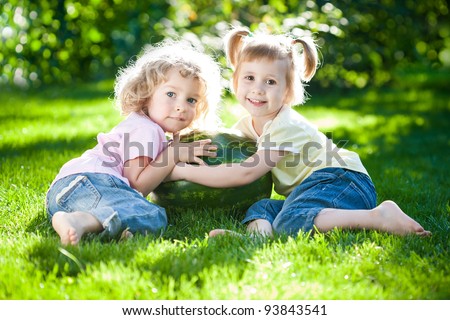 Similar – Two children laughing while playing in the playground.