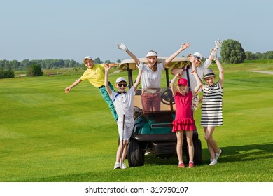 Happy children posing near golf car at golf course at summer day