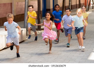 Happy Children Running In Race And Laughing Outdoors At Sunny Day