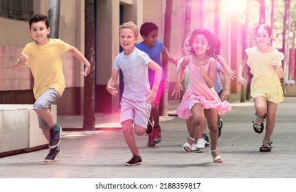 Happy Children Running In Race And Laughing Outdoors At Sunny Day