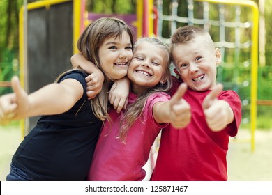 Happy Children Showing Ok Sign On Playground