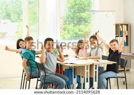 Happy children taking classes at language school