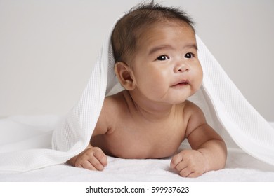 Happy Chinese Baby With Blanket Over His Head.