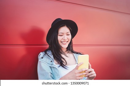 Happy Chinese Girl Using Mobile Phone Outdoor - Asian Social Influencer Woman Having Fun With New Trends Smartphone Apps - Generation Z, Media, Technology And Youth Millennial People Lifestyle