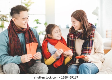 Happy Chinese New Year. Asian Family Giving Red Envelope For Lucky At Home