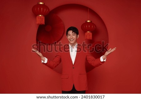 Happy Chinese new year. Asian man wearing red suit dress with gesture of welcome chinese new year 2024 isolated on red decoration background.