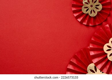 Happy Chinese New Year banner template. Traditional festival paper fans with gold flowers on red table.