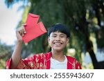 Happy Chinese new year, Chinese boy smiles happily after receiving several red red envelopes or 